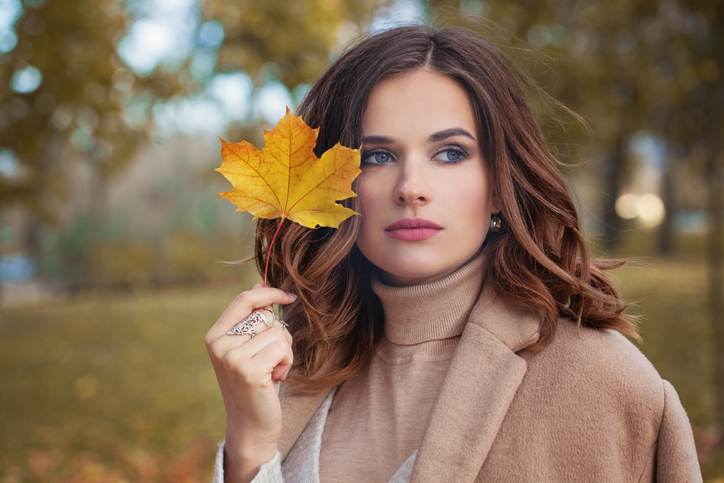 Autumn Woman with Autumn Leaves on Fall Nature Background